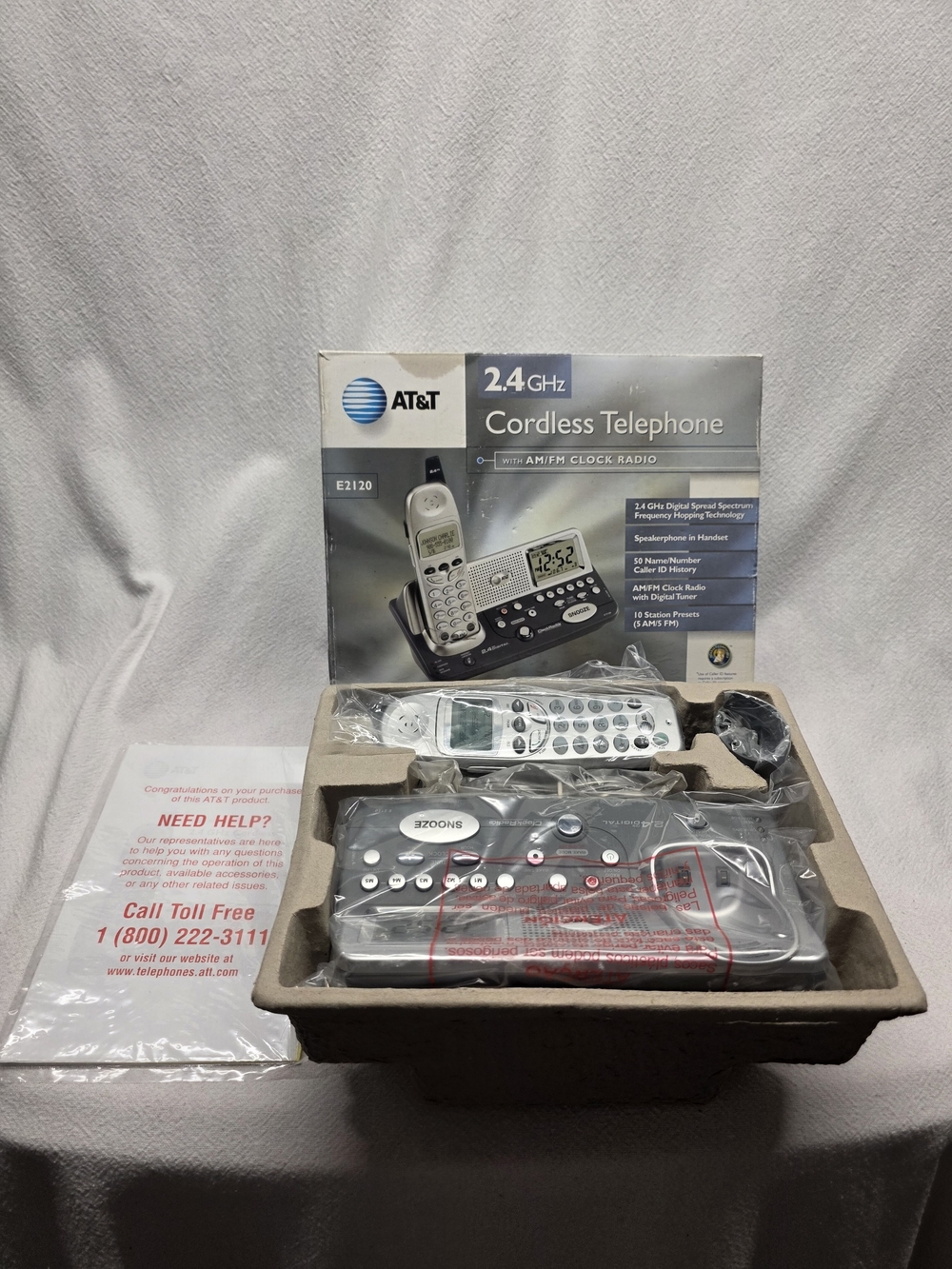 AT&T E2120 is a 2.4GHz cordless telephone that features a built-in AM/FM clock.